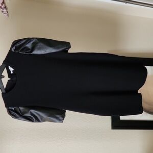 Knit little black dress with faux leather puffy sleeves